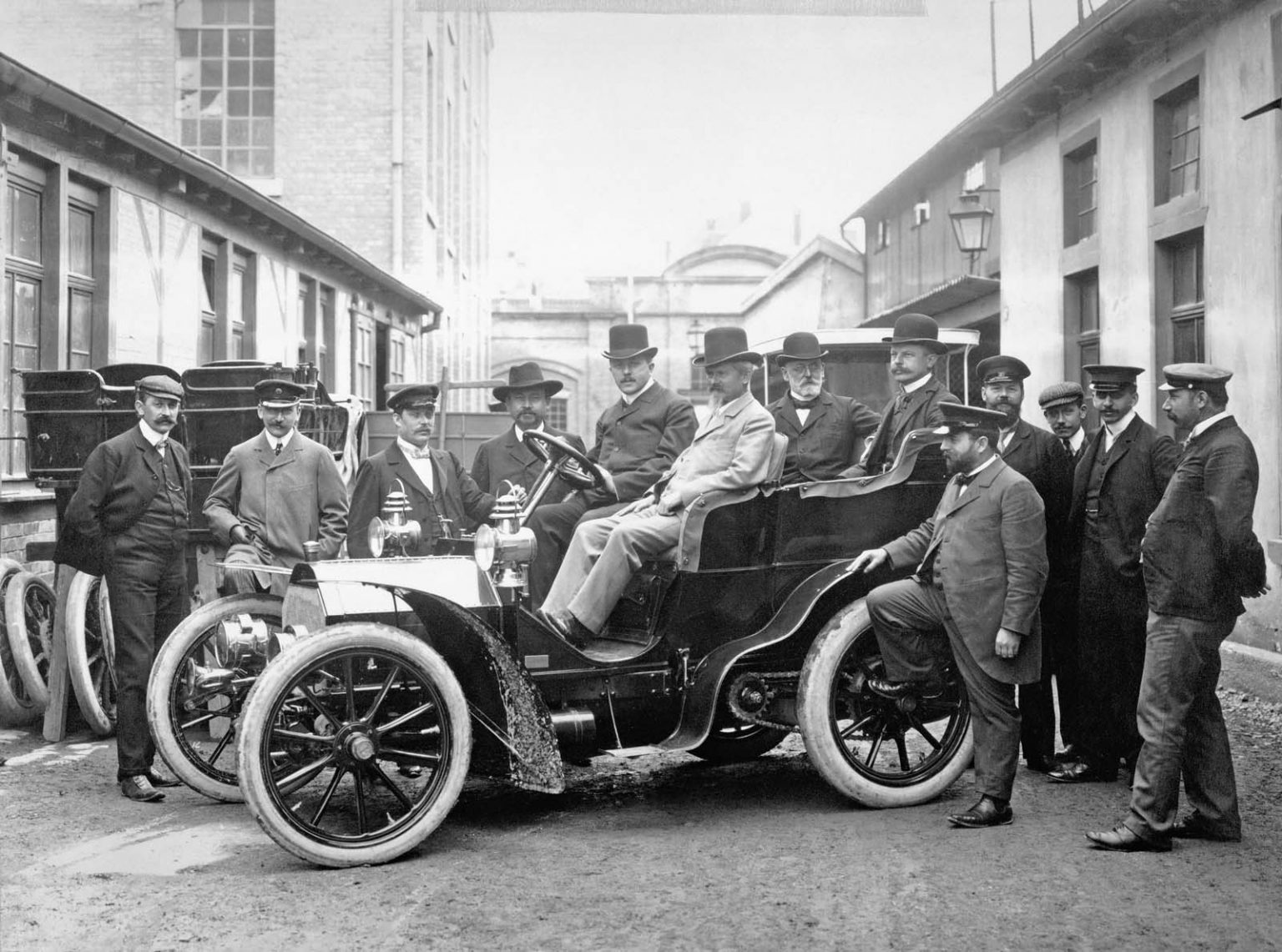 Wilhelm Maybach on the front passenger seat of a Mercedes-Simplex 18/22 hp. 1903 taken in the factory yard of Daimler-Motoren-Gesellschaft’s Cannstatt plant.